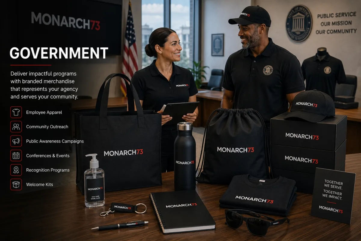A public agency office with branded polos, totes, drawstring bags, notebooks and outreach merchandise laid out on a table